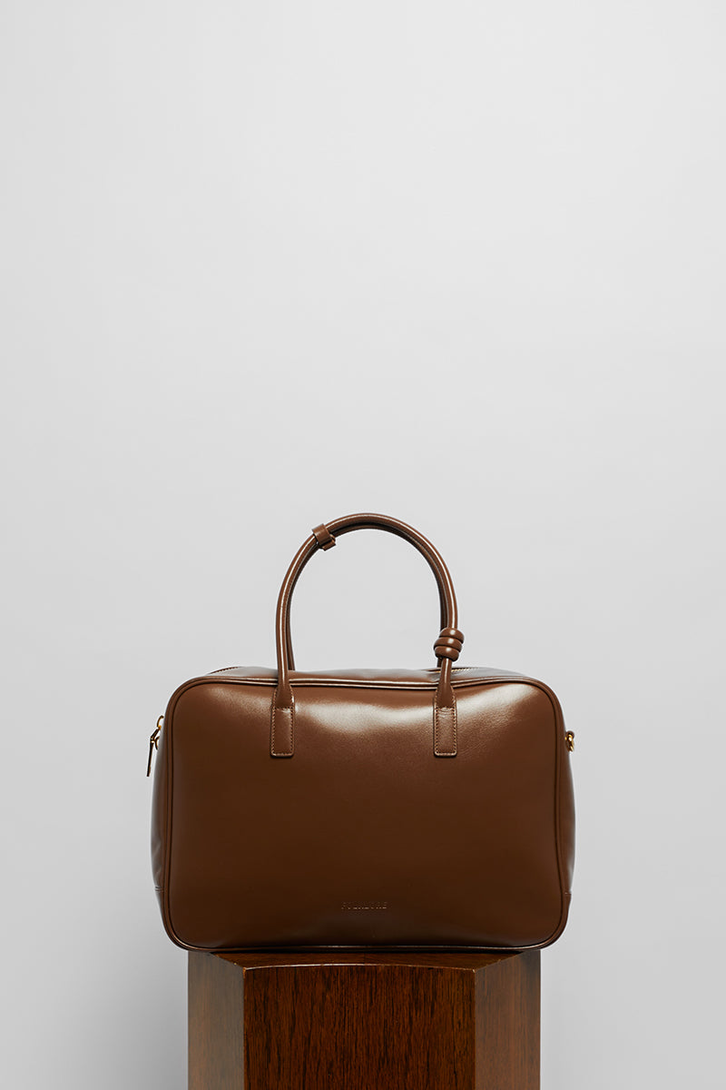 Top handle leather work bag in mocha from Folklore The Label, featuring a sleek design and sturdy leather construction.