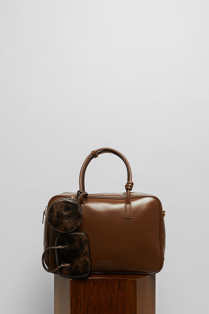 Leather work bag with top handle in mocha from Folklore The Label, featuring a sleek, structured design and smooth leather finish.
