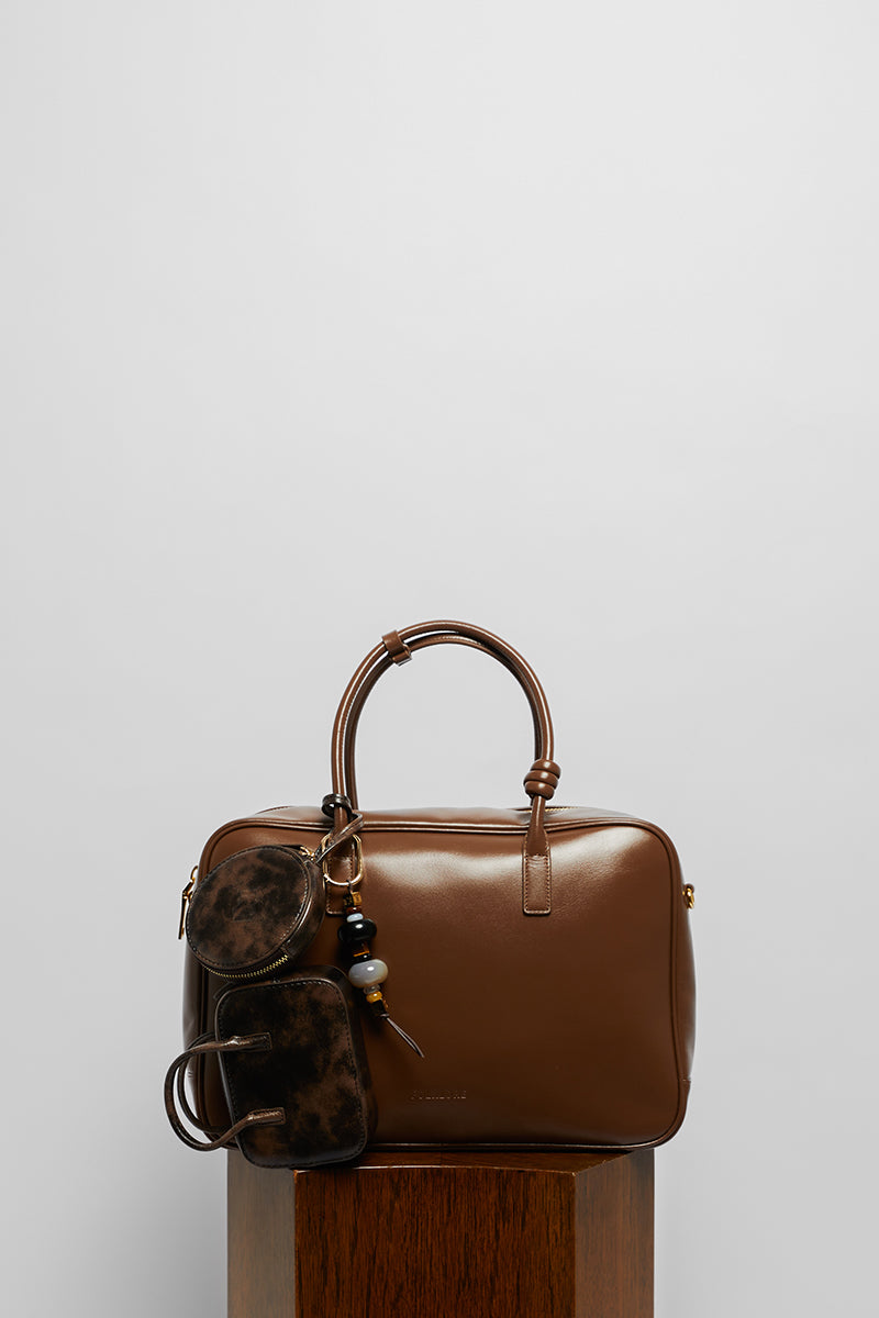 Top handle leather work bag in mocha from Folklore The Label, featuring a sleek design and sturdy leather construction.