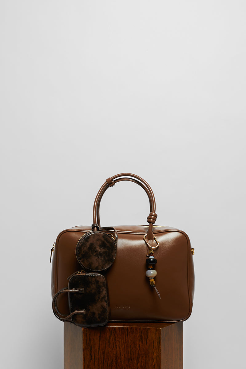 Leather work bag in mocha from FolkLore The Label, featuring a top handle design and stylish, functional storage.