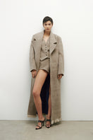 Elegant JC Pajares virgin wool coat featuring a classic tailored design and neutral color, perfect for chilly weather.