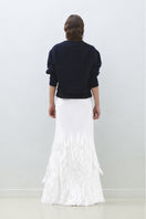 Hand embroidered white whale maxi skirt by TAGG, featuring intricate whale designs on flowing white fabric.
