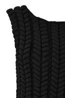 Black woven braided maxi dress by MAZ Manuela Álvarez featuring intricate details and a flowing silhouette.