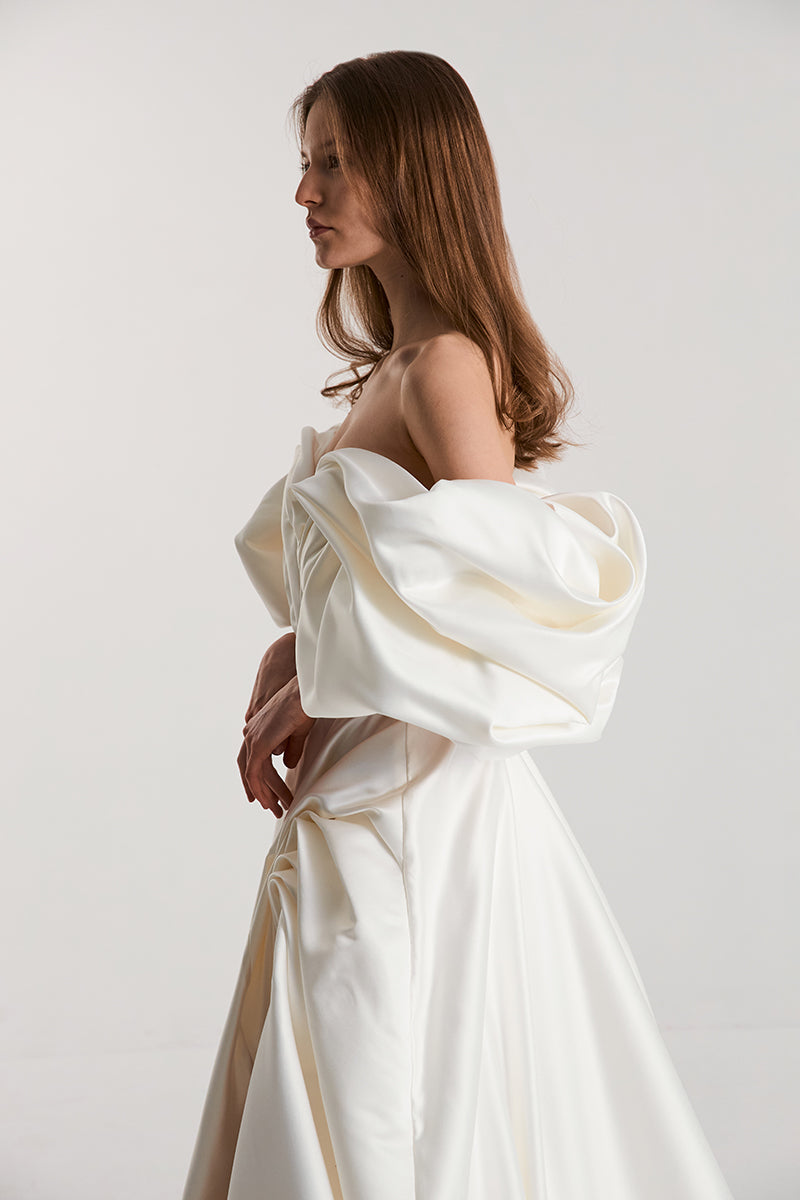 Off-White Volume Sculpted Gown by Monetre featuring a flowing, sculpted silhouette and elegant design in a dramatic evening style.