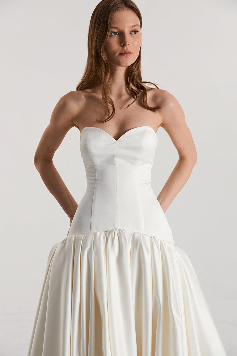 Off-white satin figure dress by Monetre featuring a flowing maxi design and elegant silhouette, perfect for formal occasions.