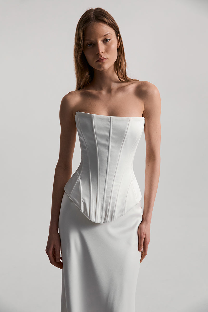 Off-white satin Dita corset top by Monetre, featuring a fitted design and elegant detailing.