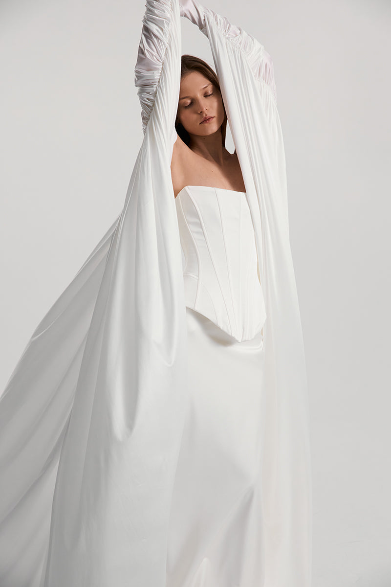 Off-white satin DITA corset top by Monetre, featuring structured design and elegant detailing, displayed on a plain background.
