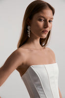 Off-white satin DITA corset top by Monetre with structured fit and detailed design, shown in a stylish close-up image.