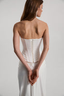 Off-white satin DITA corset top by Monetre featuring structured design and elegant fit, shown on a neutral background.