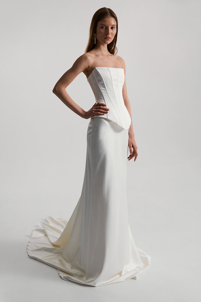 Off-white satin corset top by Monetre, featuring structured design and elegant styling, shown on a model.