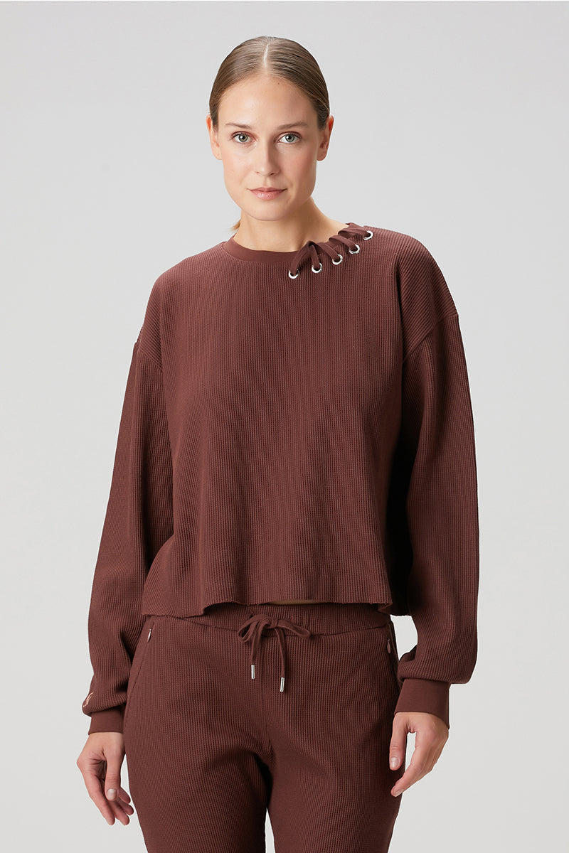 Brown Bassigue waffle crewneck sweatshirt with textured knit fabric and ribbed cuffs, casual and comfortable sweater for everyday wear.