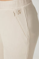 Beige waffle sweatpants by Bassigue, casual pants with textured fabric, elastic waistband, and relaxed fit.
