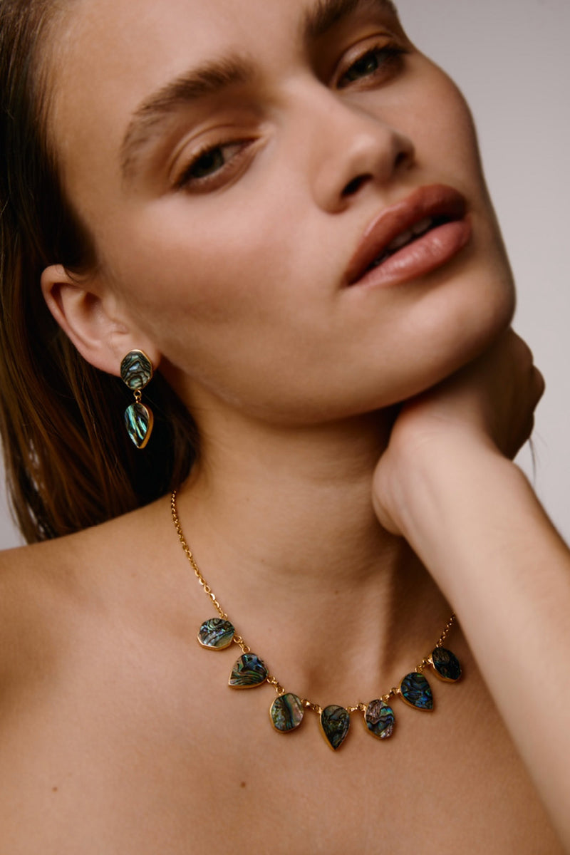 Silver drop earrings with Paua shell inlay by Freya Rose, featuring intricate warrior-inspired design.