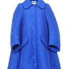 Blue quilt swing coat by Chictopia displayed on a hanger, showcasing its quilted pattern and stylish design.