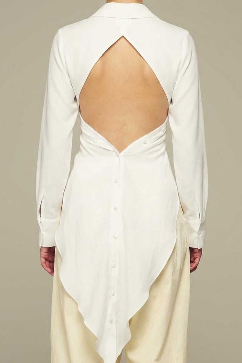 White Ulysse shirt by IKINITA, shown hanging on a wooden hanger with a simple, clean design and classic collar.