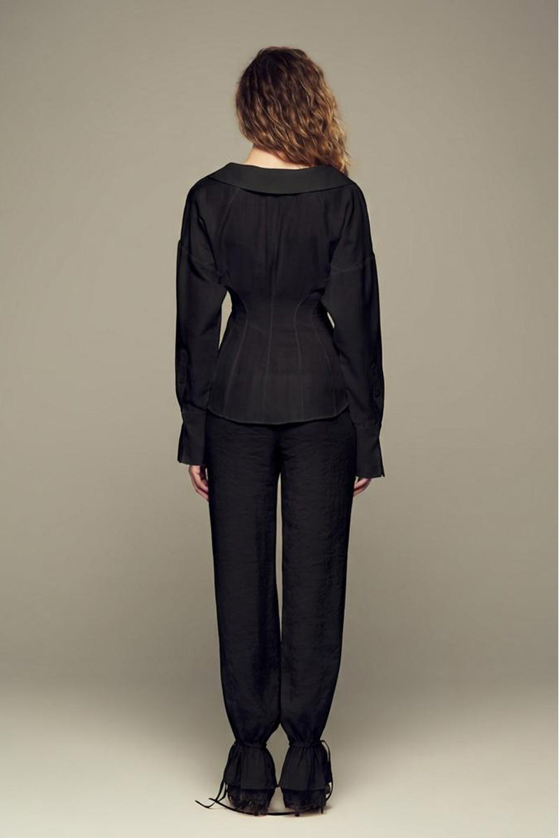 Black Scylla Pants by IKINITA, shown on a model, featuring a stylish, tailored fit with clean lines and comfortable fabric.