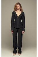 Black Scylla pants by IKINITA shown in the image, featuring a sleek, tailored design perfect for stylish casual or semi-formal wear.