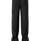 Black Scylla pants by IKINITA displayed on a model, showcasing their stylish fit and comfortable design.