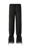 Black Scylla pants by IKINITA displayed on a model, showcasing their stylish fit and comfortable design.