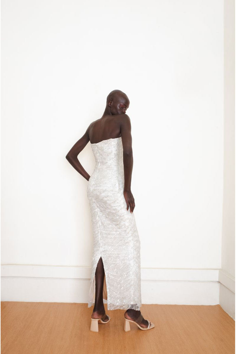Silver YASSMIN SALEH Whispers Gown with elegant back design, flowing fabric, perfect for formal occasions.