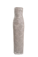 Silver ghost-style gown from Yassmin Saleh featuring flowing fabric and elegant design, displayed on a mannequin.