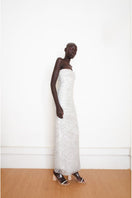 Silver YASSMIN SALEH Whispers Gown shown from the side, featuring elegant fabric and detailed design for formal occasions.