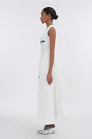 White asymmetrical flared maxi dress by Tiny Ink, flowing fabric with a unique hemline, perfect for elegant summer occasions.