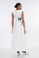White asymmetrical flared maxi dress by Tiny Ink, featuring flowing fabric and stylish design, perfect for elegant occasions.
