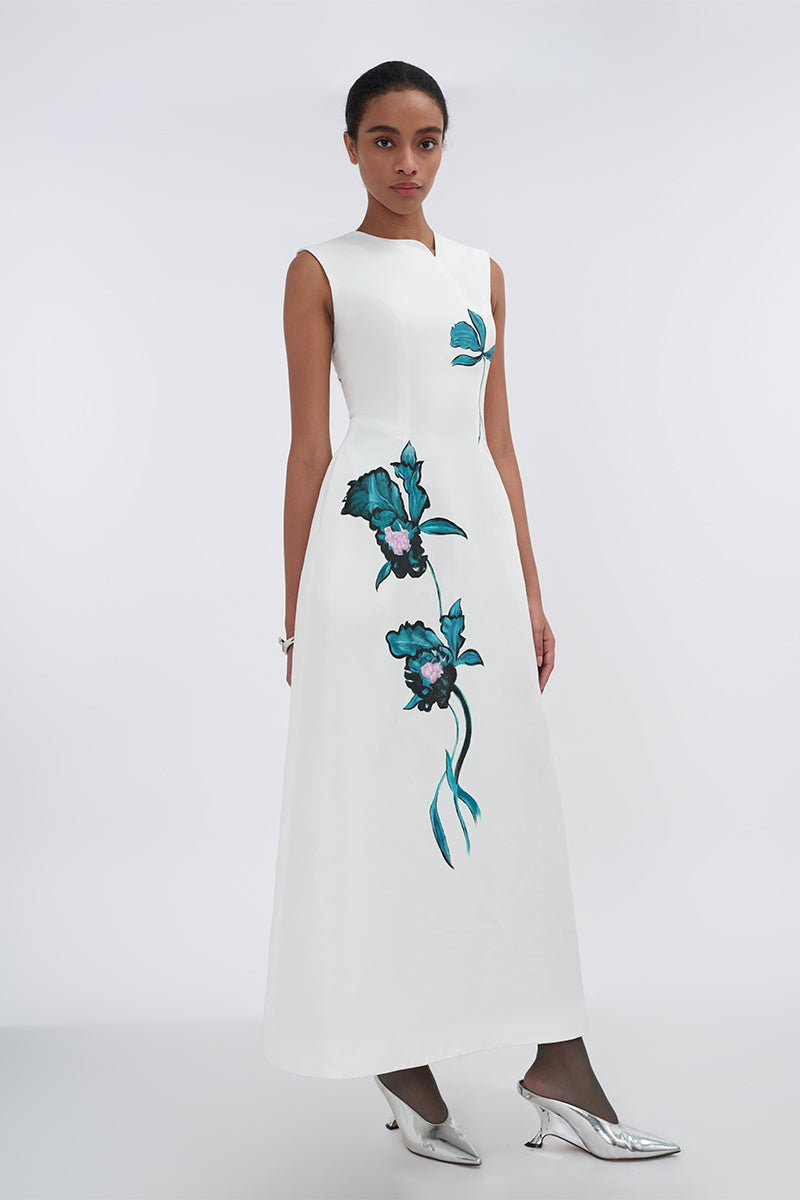 White asymmetrical flared maxi dress by Tiny Ink, featuring flowing fabric and stylish uneven hem for a chic summer look.
