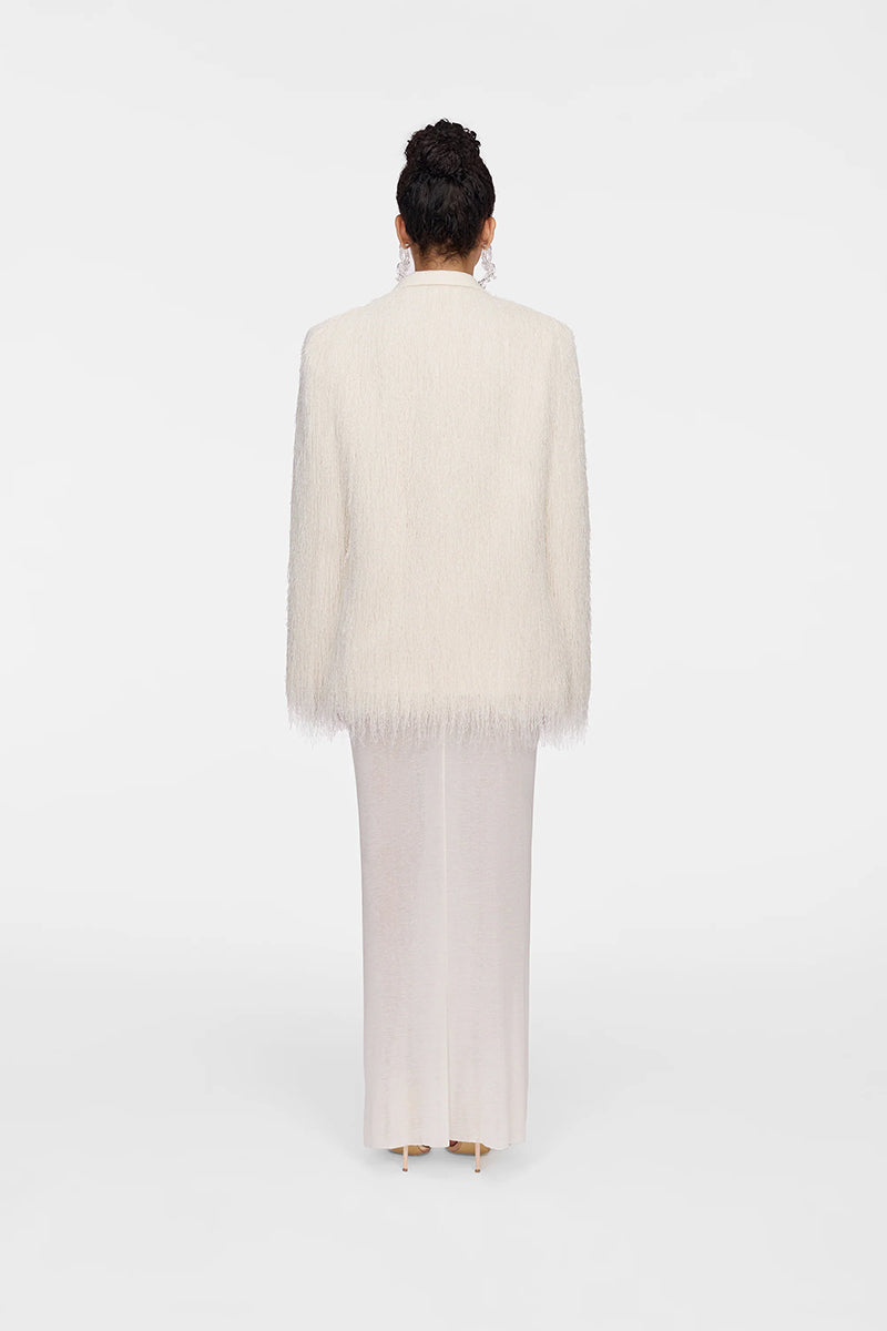 White Montsand Bailey jacket displayed on a hanger, showcasing its clean design and lightweight fabric.
