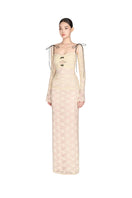 White maxi dress with cut-out lace details by Montsand, featuring a flowing silhouette and elegant design.