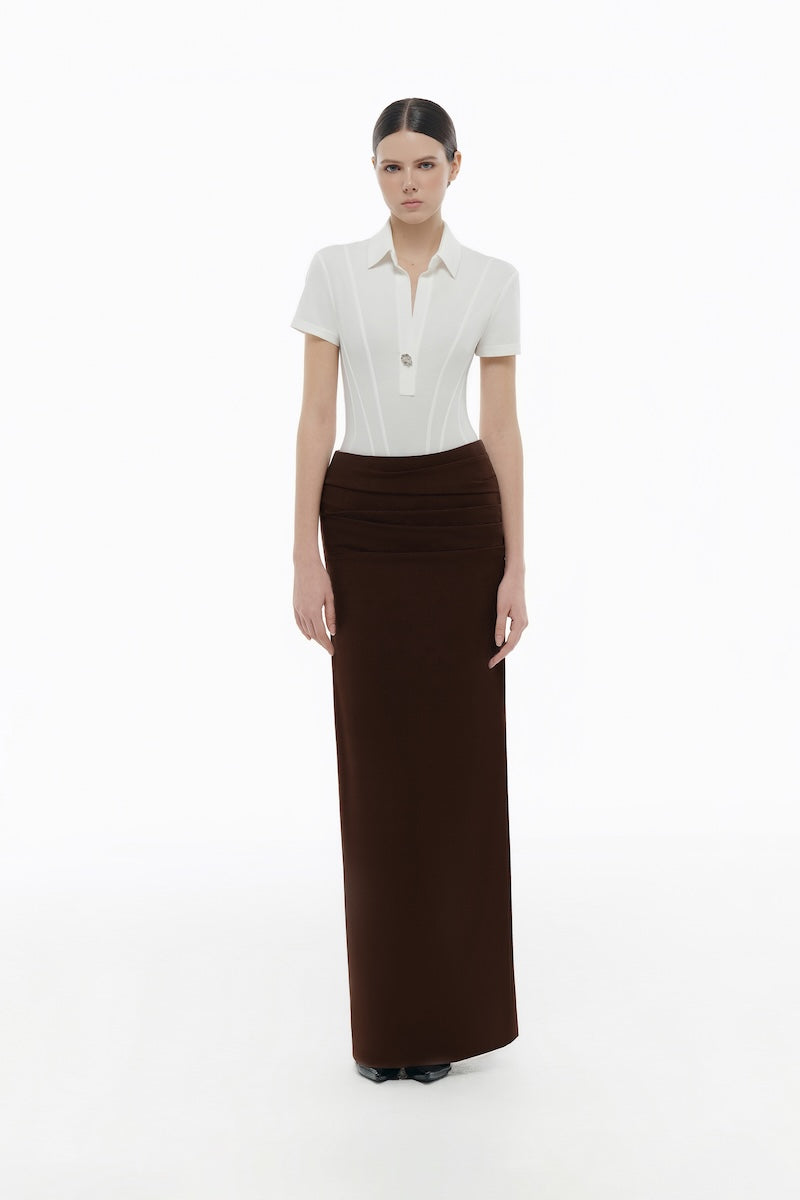 White corset polo shirt by Montsand, featuring a fitted design, collar, and button details, displayed on a plain background.