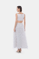 White 3D floral midi skirt by Montsand, featuring a flowy design and intricate floral pattern, paired with a white crop top.