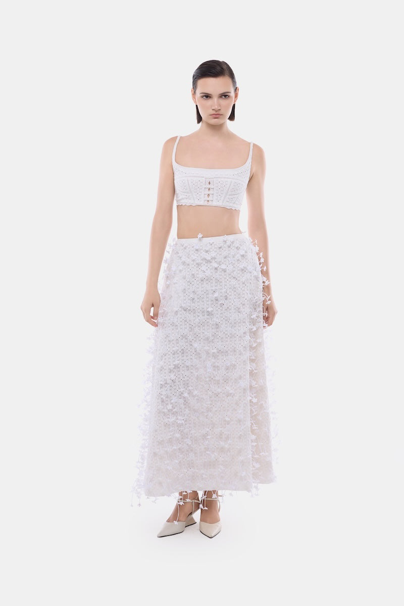 White 3D floral midi skirt by Montsand, featuring a stylish design with textured floral details, paired with a white crop top.