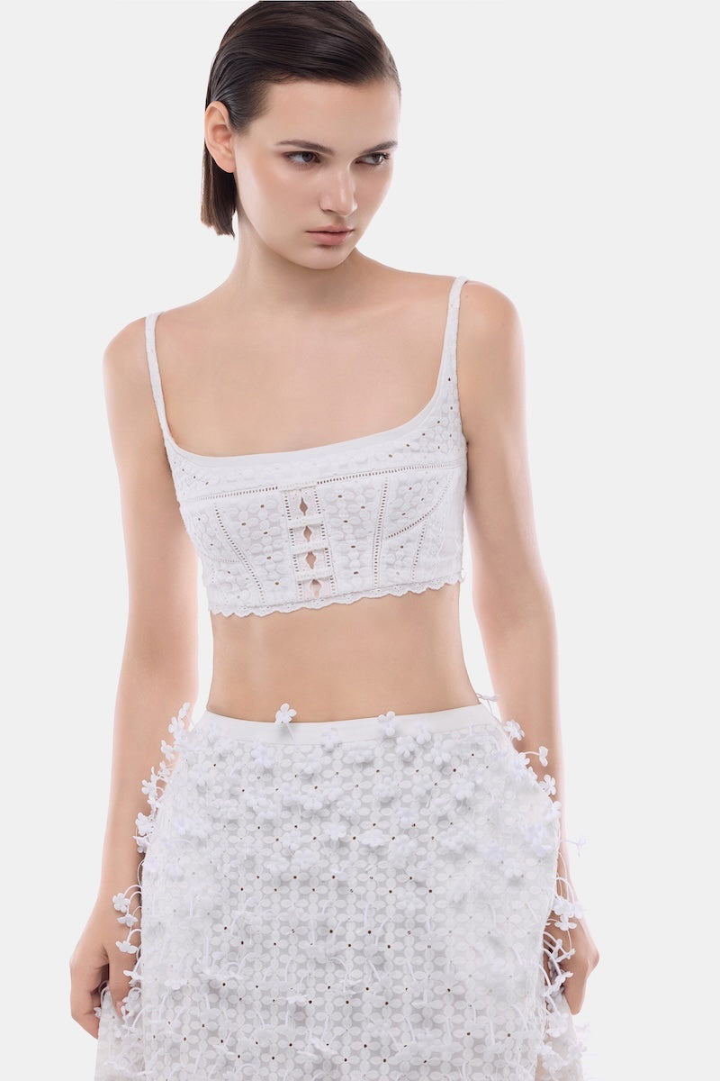 White 3D floral midi skirt by Montsand featuring a flowy design and intricate floral details, paired with a white crop top.