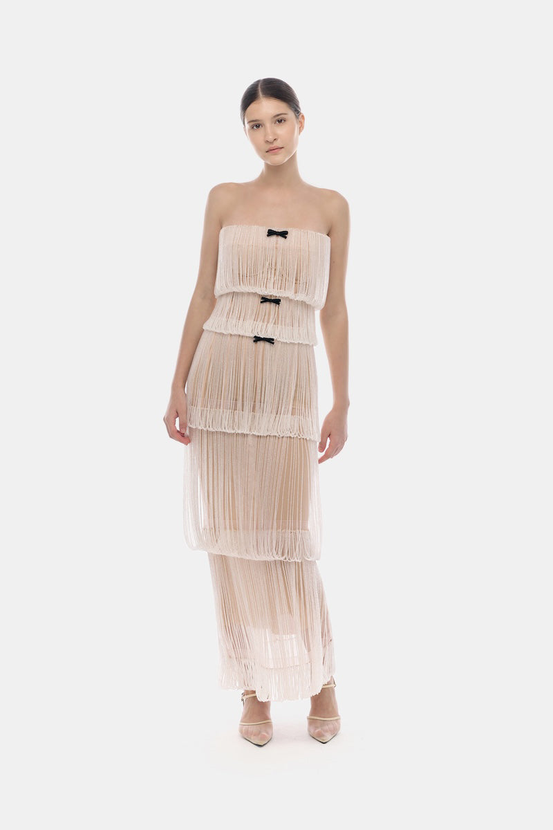 White fringe tube maxi dress by Montsand, featuring a sleeveless design with flowing fabric and stylish fringe details.