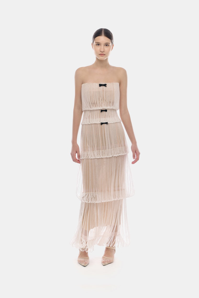 White fringe tube maxi dress by Montsand featuring a flowing silhouette and sleeveless design, perfect for summer events.