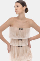 White fringe tube maxi dress by Montsand, sleeveless with flowing fabric and fashionable fringe detailing.