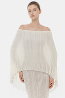 White off-shoulder pleated maxi dress by Montsand, flowing fabric, elegant design, perfect for summer or formal occasions.