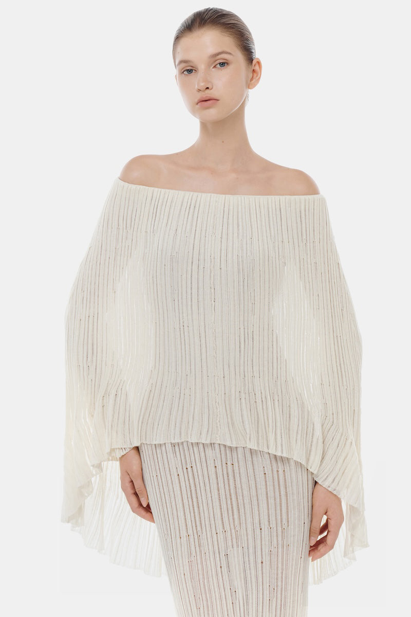 White off-shoulder pleated maxi dress by Montsand, flowing fabric, elegant design, perfect for summer or formal occasions.
