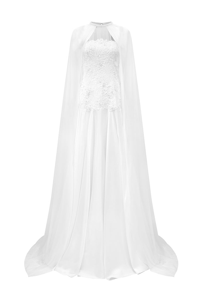 White taffeta maxi dress with cape by Tracy Studio, featuring elegant draping and a flowing silhouette.