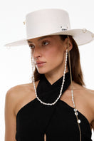 White canotier hat by LE SH KA with a wide brim and lightweight fabric, perfect for stylish sun protection.
