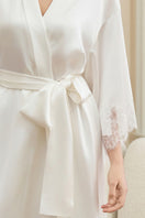 Woman wearing a luxurious black silk robe by MANITO, showcasing the elegant WINDY women's silk robe with flowing fabric.