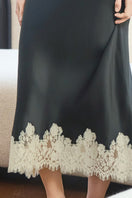 Black Windy Women's Silk Midi Skirt by MANITO, flowing fabric with elegant design, shown on a model.