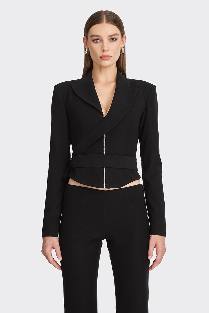 Black wrap blazer from Stolen Stores featuring a tailored fit, lapel collar, and long sleeves, styled on a model.
