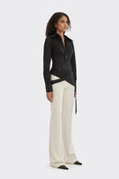 Black wrap button shirt from Stolen Stores, showcasing a stylish design with a collar and long sleeves.