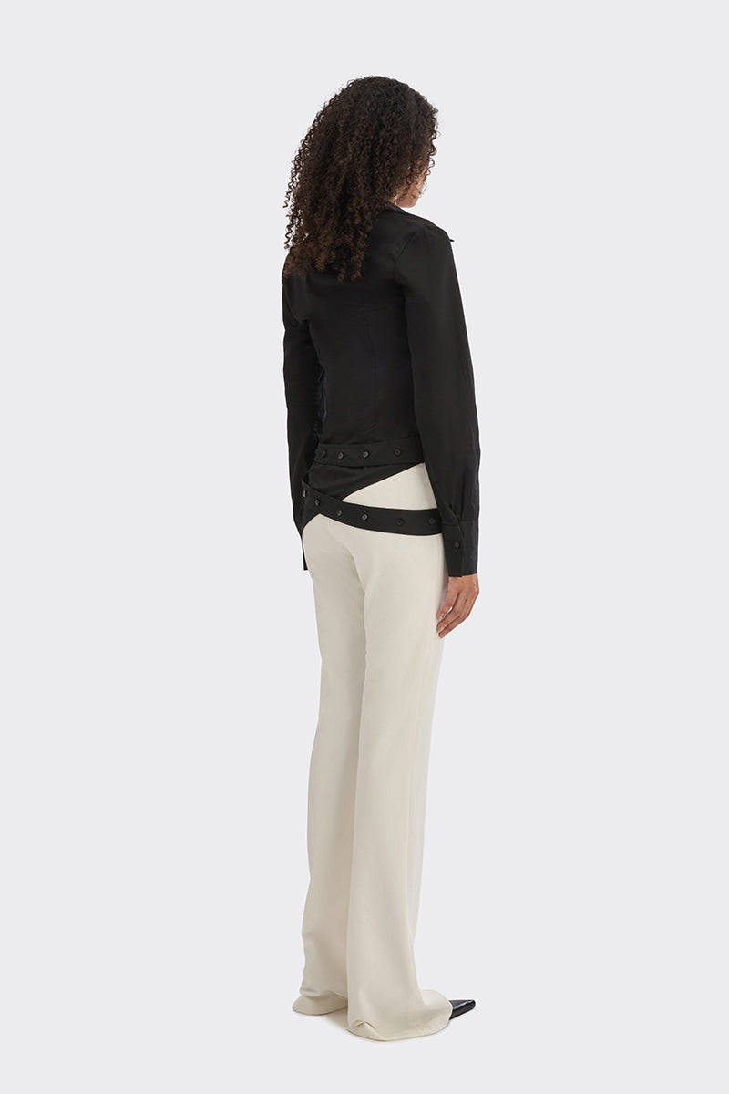 Black wrap button shirt from Stolen Stores with long sleeves and a collared neckline, displayed on a hanger.
