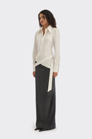 White wrap button shirt from Stolen Stores, featuring a stylish design and classic collar, displayed on a hanger.