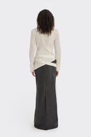 White wrap button shirt from Stolen Stores, featuring a stylish collar and long sleeves, displayed on a hanger.