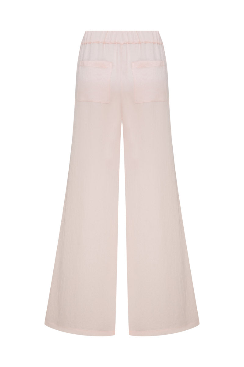 Tagg satin loose pants with elastic waistband, showcasing a smooth, shiny fabric and relaxed fit on a model.
